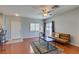 Cozy living room with wood floors, ceiling fan, and access to the entry door at 9362 Straw Hays St # 103, Las Vegas, NV 89178