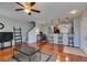 Living room featuring hardwood floors, recessed lights, a ceiling fan, kitchen access, and a staircase at 9362 Straw Hays St # 103, Las Vegas, NV 89178