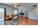 Living room with hardwood floors, a sofa, ceiling fan, recessed lights, and backyard access at 9362 Straw Hays St # 103, Las Vegas, NV 89178