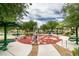 Park featuring outdoor workout equipment and picnic tables surrounded by trees, ideal for an active lifestyle at 9362 Straw Hays St # 103, Las Vegas, NV 89178
