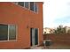 View of the backyard showing the sliding glass door, an air conditioner, and a block wall at 9402 Crimson Sky St, Las Vegas, NV 89178