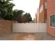 Small backyard area with a white vinyl fence and a block wall at 9402 Crimson Sky St, Las Vegas, NV 89178