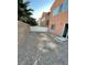 Spacious backyard with a gravel ground, partial block wall, and a white vinyl fence at 9402 Crimson Sky St, Las Vegas, NV 89178