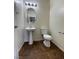 This half bathroom includes a pedestal sink and commode at 9402 Crimson Sky St, Las Vegas, NV 89178