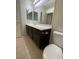 Well-lit bathroom featuring a large vanity, mirror, and tiled floors at 9402 Crimson Sky St, Las Vegas, NV 89178