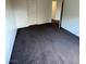 View of the bedroom with neutral walls and carpet, along with a bright white door at 9402 Crimson Sky St, Las Vegas, NV 89178