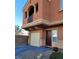 Two-story home with desert landscaping, featuring a garage and a balcony at 9402 Crimson Sky St, Las Vegas, NV 89178