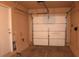 Two car garage featuring a roll up door and a side entry door at 9402 Crimson Sky St, Las Vegas, NV 89178