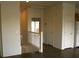 Upstairs landing with white railings, doors, and a glimpse of the kitchen at 9402 Crimson Sky St, Las Vegas, NV 89178