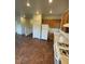 Cozy kitchen features wood cabinets and white appliances at 9402 Crimson Sky St, Las Vegas, NV 89178