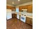The kitchen has wooden cabinets, tile floors, and modern appliances at 9402 Crimson Sky St, Las Vegas, NV 89178