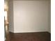 Neutral living area with plain wall, and dark brown hardwood flooring at 9402 Crimson Sky St, Las Vegas, NV 89178