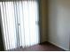 A bright living room featuring sliding glass doors and dark hardwood floors at 9402 Crimson Sky St, Las Vegas, NV 89178