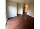 Bright living room with light walls and dark faux wood floors at 9402 Crimson Sky St, Las Vegas, NV 89178