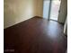 Living room with hard surface flooring and a sliding glass door for backyard access at 9402 Crimson Sky St, Las Vegas, NV 89178