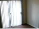 A well-lit living room featuring sliding glass doors and dark hardwood floors at 9402 Crimson Sky St, Las Vegas, NV 89178