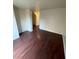 A bright living room featuring sleek hardwood floors and neutral walls, creating a versatile space at 9402 Crimson Sky St, Las Vegas, NV 89178