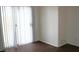 Living room featuring sliding glass doors, hardwood floors, and neutral walls at 9402 Crimson Sky St, Las Vegas, NV 89178