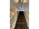 Carpeted staircase with a ceiling fan visible at the top of the stairs at 9402 Crimson Sky St, Las Vegas, NV 89178
