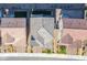 An aerial view displays the roof of a modern home with neutral tones, surrounded by landscaped yards and neighboring houses at 9476 Lunar Phase St, Las Vegas, NV 89143