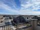 Balcony view showcases a residential neighborhood, blue sky, and distant mountain landscape at 9476 Lunar Phase St, Las Vegas, NV 89143