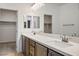 Bathroom featuring double sinks with modern fixtures, vanity storage and access to the closet at 9476 Lunar Phase St, Las Vegas, NV 89143