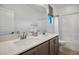Bathroom featuring a double vanity with quartz countertops, and a tub with shower at 9476 Lunar Phase St, Las Vegas, NV 89143