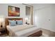 Comfortable bedroom with a modern wooden bed frame, plush bedding, and a large closet at 9476 Lunar Phase St, Las Vegas, NV 89143