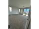 Bright bedroom featuring carpet floors, mountain views, and large sliding glass doors to a balcony at 9476 Lunar Phase St, Las Vegas, NV 89143