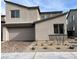 Modern two-story home featuring desert landscaping, a two-car garage, and neutral tones at 9476 Lunar Phase St, Las Vegas, NV 89143