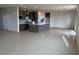 Open floor plan highlighting a kitchen island, gray cabinets, and tile flooring at 9476 Lunar Phase St, Las Vegas, NV 89143