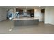 Open kitchen featuring an island, gray cabinets, stainless appliances, and neutral tile flooring at 9476 Lunar Phase St, Las Vegas, NV 89143