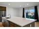 Spacious kitchen island with a sink, dishwasher, and bar seating, perfect for entertaining at 9476 Lunar Phase St, Las Vegas, NV 89143