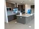 Spacious kitchen features a large island, gray cabinets, and stainless steel appliances at 9476 Lunar Phase St, Las Vegas, NV 89143