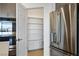 Stainless steel refrigerator and pantry with shelving provide ample storage in this modern kitchen at 9476 Lunar Phase St, Las Vegas, NV 89143