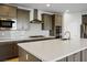 Gourmet kitchen with stainless steel appliances, an island, and a breakfast bar at 9476 Lunar Phase St, Las Vegas, NV 89143