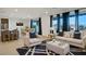 Bright, open-concept living room with modern furnishings and large windows with mountain views at 9476 Lunar Phase St, Las Vegas, NV 89143
