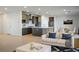 Open-concept living area with modern decor seamlessly blending into a spacious kitchen and dining space at 9476 Lunar Phase St, Las Vegas, NV 89143