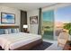 Bright main bedroom with mountain views from the sliding doors to a private balcony at 9476 Lunar Phase St, Las Vegas, NV 89143