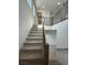 Carpeted stairs with modern railing lead to the upper level of this home at 9476 Lunar Phase St, Las Vegas, NV 89143