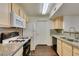 Galley kitchen with granite countertops, stainless steel sink, and gas range at 950 Seven Hills Dr # 524, Henderson, NV 89052