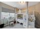 Bedroom featuring a charming white bunk bed, window with blinds, and vanity set at 9835 Fox Estate St, Las Vegas, NV 89141