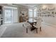 Bright dining room featuring a large table, bench, stylish chairs, and contemporary decor at 9835 Fox Estate St, Las Vegas, NV 89141