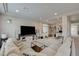 Living room featuring a large sectional sofa, TV, and desk, ideal for relaxation and productivity at 9835 Fox Estate St, Las Vegas, NV 89141