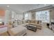 Spacious living room with large sectional sofa, complemented by natural light, creating a cozy atmosphere at 9835 Fox Estate St, Las Vegas, NV 89141