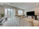 A cozy living room with a sectional sofa, balcony and modern design at 9835 Fox Estate St, Las Vegas, NV 89141