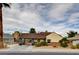 Charming single-story home with gated carport, desert landscaping, and mature palm tree at 1017 E Oakey Blvd, Las Vegas, NV 89104