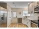 Modern kitchen featuring white cabinets, stainless steel appliances, and a stylish backsplash at 1017 E Oakey Blvd, Las Vegas, NV 89104