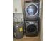 Laundry area features a stacked washer and dryer and modern tankless water heater at 1017 E Oakey Blvd, Las Vegas, NV 89104