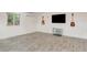 Living room with wood-look tile floors and a minimalistic design featuring wall-mounted guitars at 1017 E Oakey Blvd, Las Vegas, NV 89104